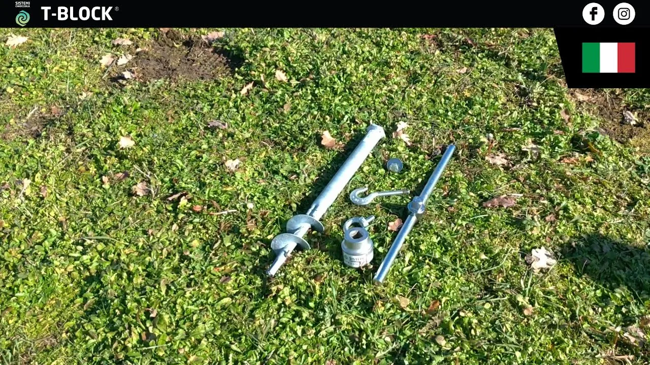 Su un prato, un T-Block da 50 cm con testa esagonale, la bussola, il manico a T, un golfare e una rondella.